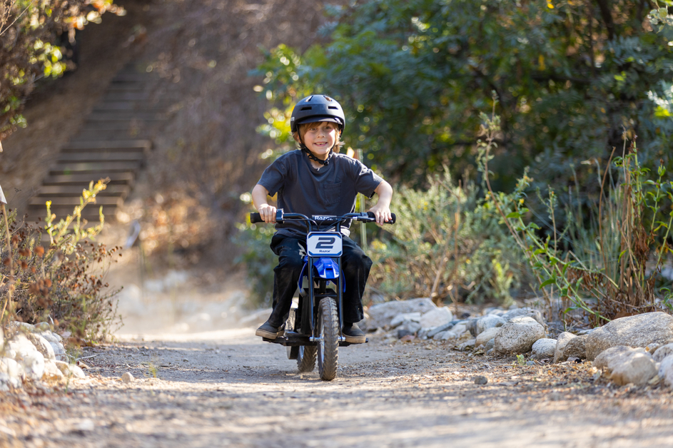 Kid riding the Razor MX125 on a path
